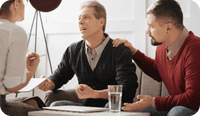 Two therapists and their client discuss emotional triggers in relationships.