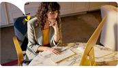 A female therapist types on her computer keyboard as she accesses her AI for therapists session notes