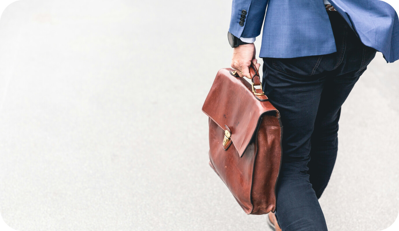 A therapist carrying a leather bag considers how to quit their therapist job