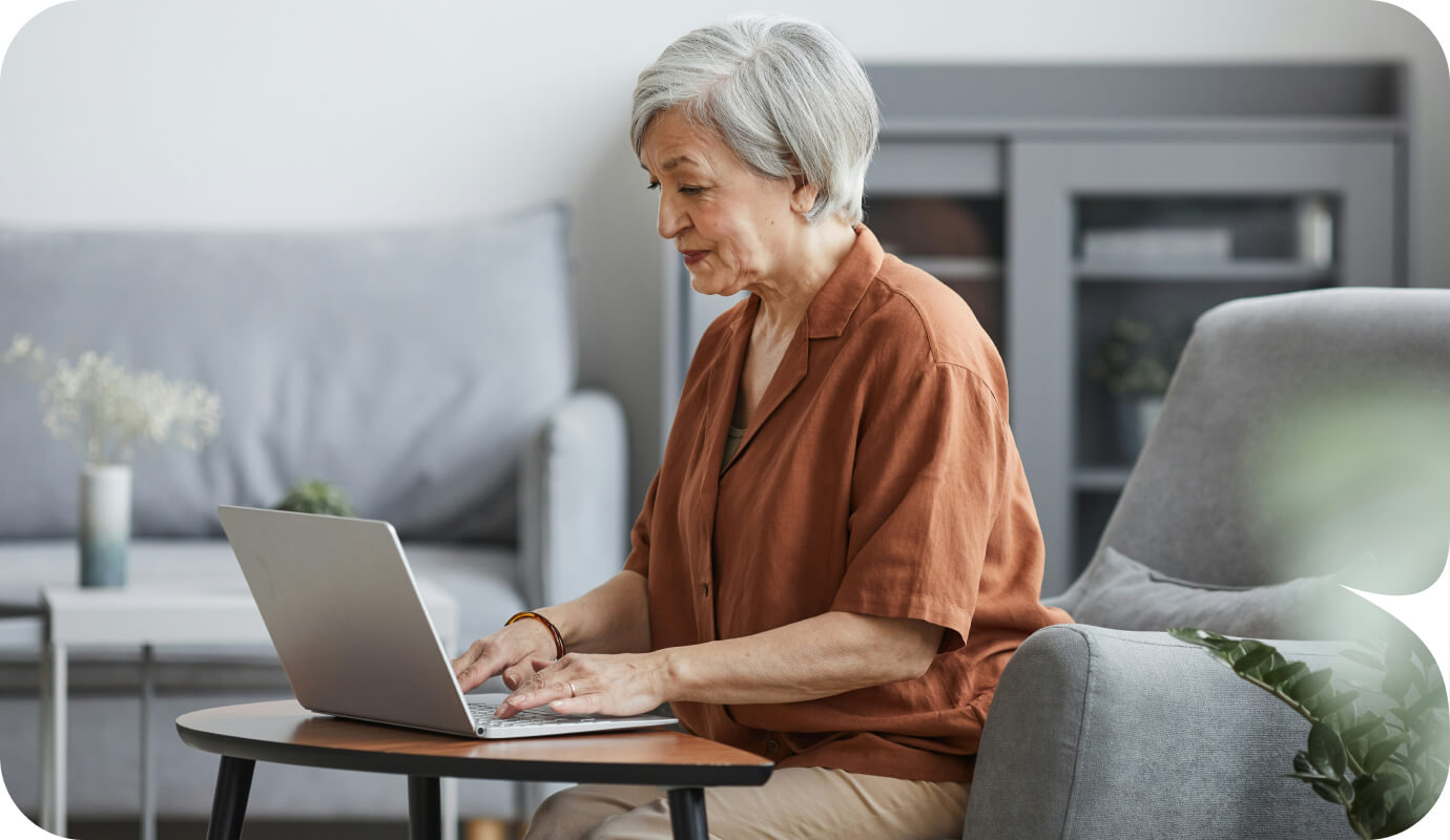 A therapy has her laptop open and is typing, searching “What does EHR stand for?” online.