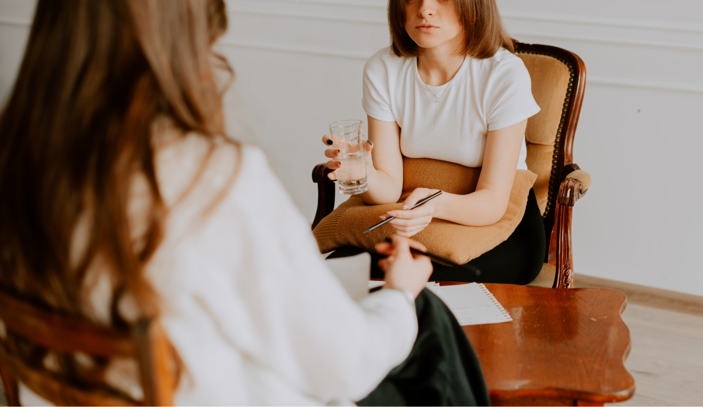 A therapist sits across from their client who is holding a pillow, the therapist finds alternatives to figuring out how to help without compromising their therapist boundaries.