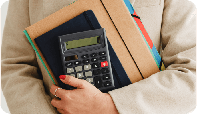 A female therapists holds onto her calculator and bookkeeping ledger