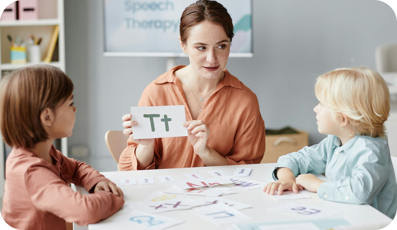 A speech language pathologist, or SLP, uses flashcards to help her students with sounding out the letter T. This is part of her evaluation to distinguish speech delay vs autism symptoms in her clients.