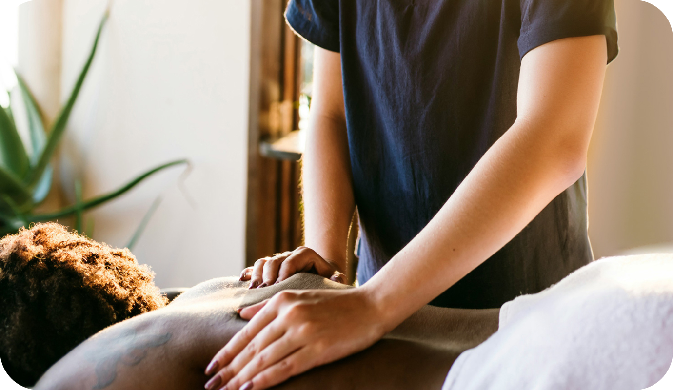 A massage therapist is massaging one of their clients' back. Learn how to get a massage therapy license—and kickstart your career in massage therapy.