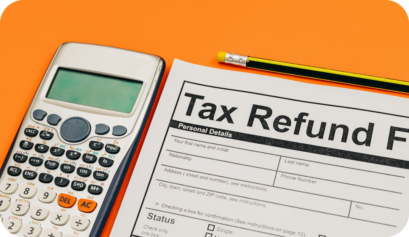 A calculator appears alongside a tax refund form for therapists setting goals for their practice