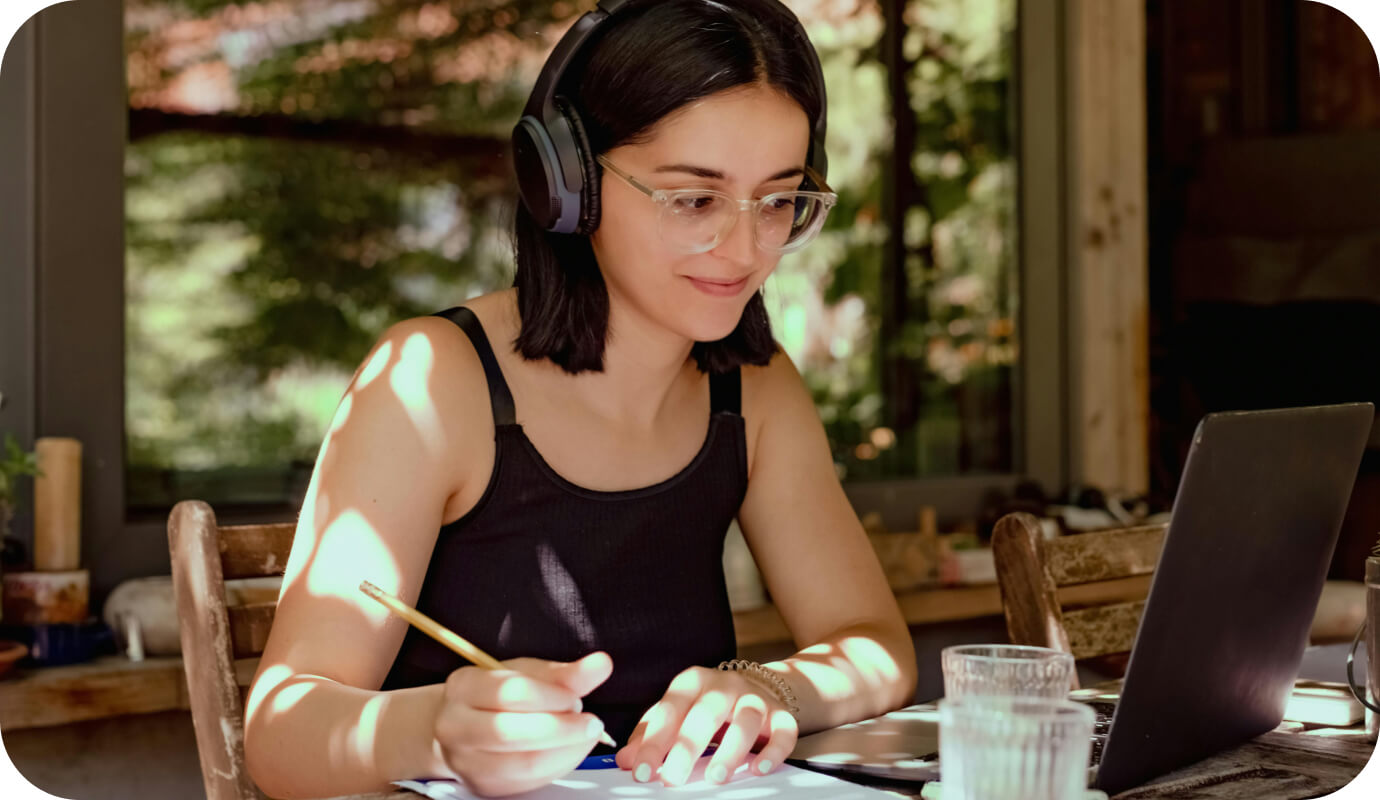 A therapist writes with pen and paper to capture therapist session notes following a client session