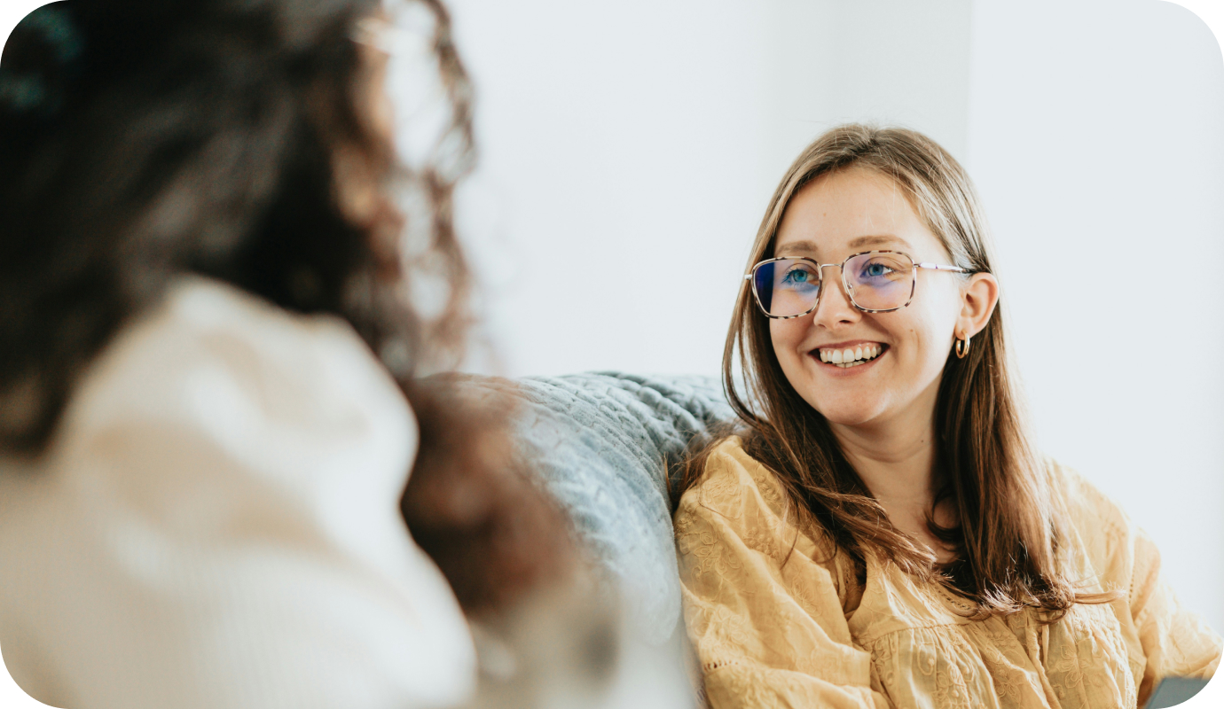 A female therapist talks with a young female client to explain what is emotional literacy.